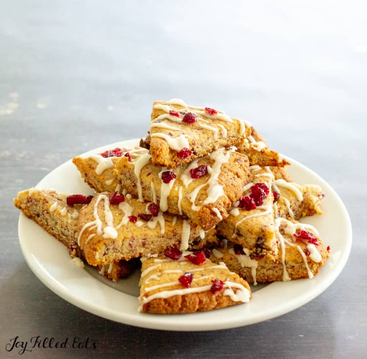 pile of lemon drizzle cranberry cookies on a white plate