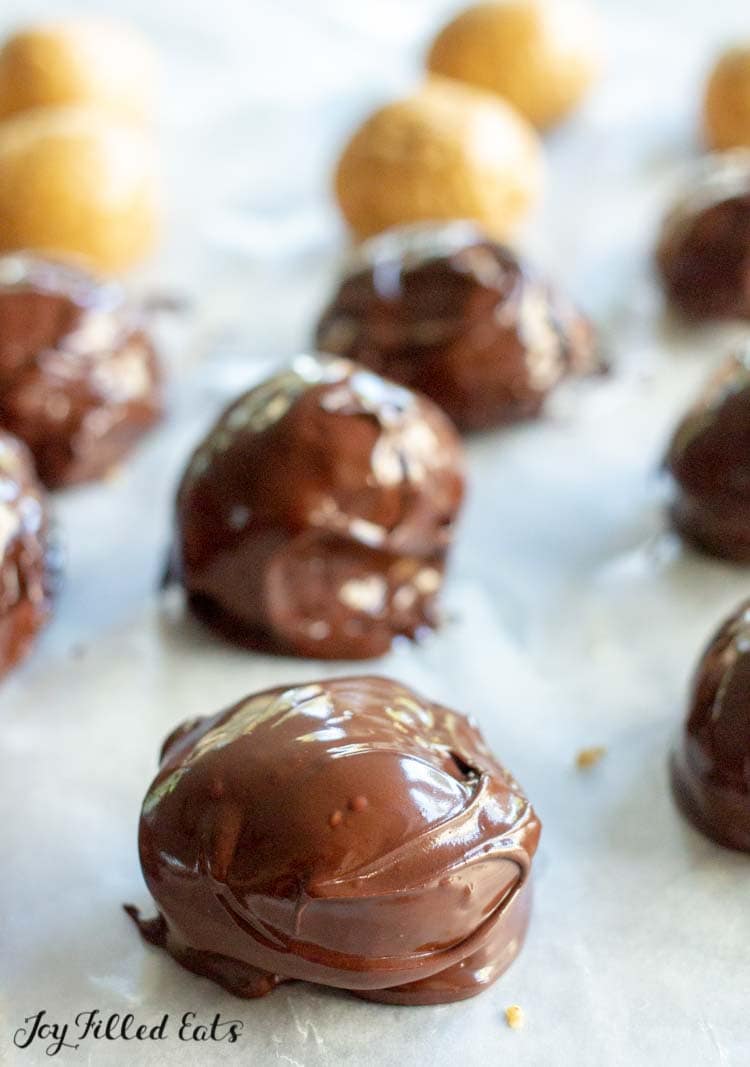 close up of peanut butter balls coated in chocolate