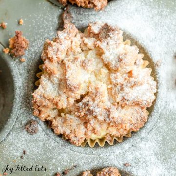 Overhead close up view of keto coffee cake muffin in metal muffin tin