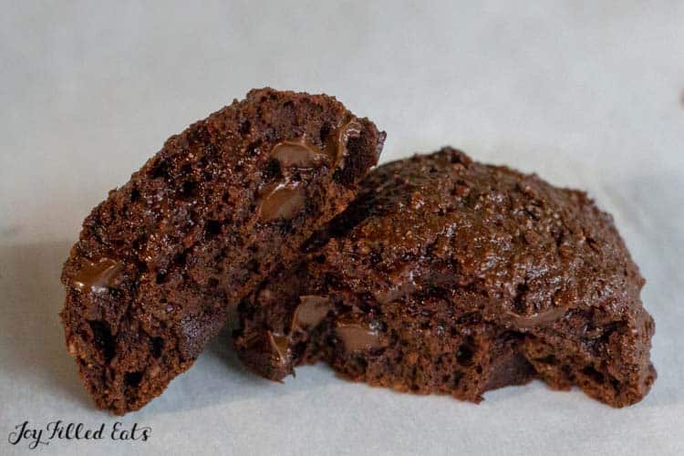 two halves of a brownie cookie leaning on each other close up