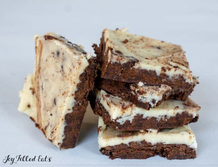 stack of peppermint cookies and cream bars with one bar leaning on the stack