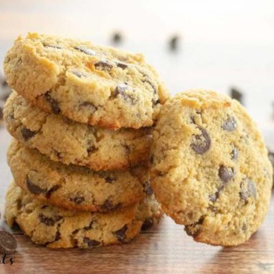stack of eggless chocolate chip cookies with one cookie leaning on stack