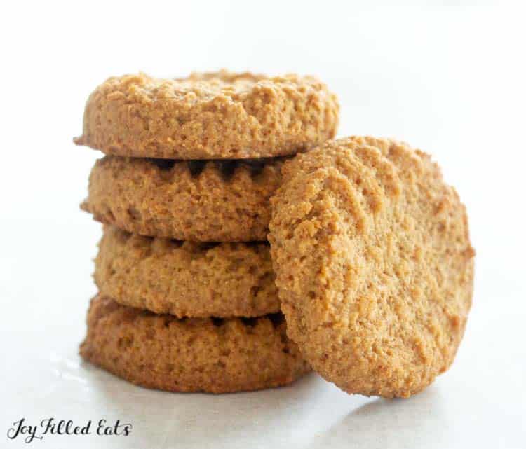 stack of peanut butter cookies with one cookie leaning on stack