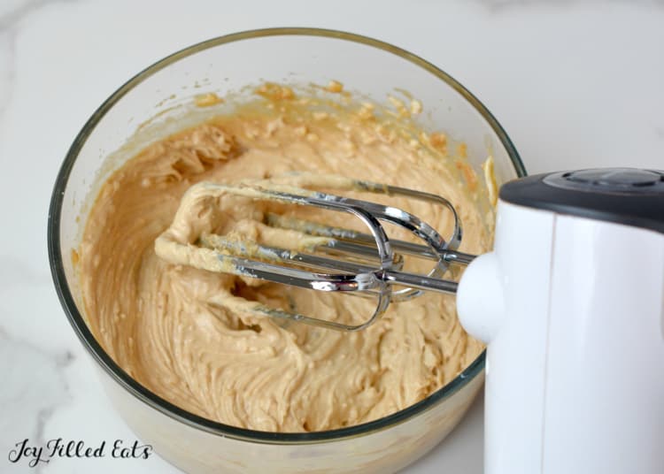 mixing bowl with hand mixer of peanut butter bar batter