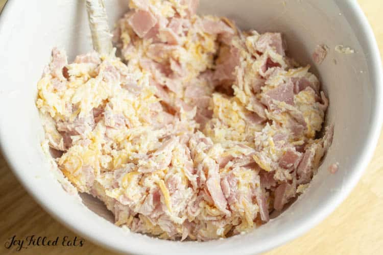 Ham and cheese stuffed mushroom filling in white mixing bowl