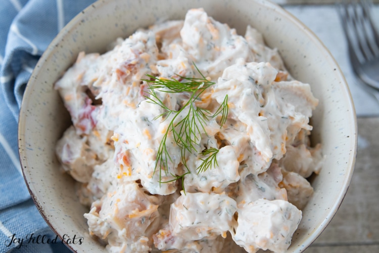 Close up of Keto Bacon Ranch Chicken Salad topped with fresh dill