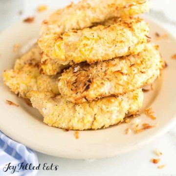 pile of coconut chicken tenders in a shallow bowl