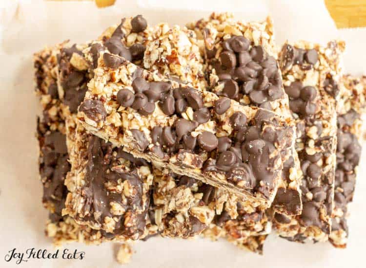 pile of no bake keto granola bars on a white plate from above
