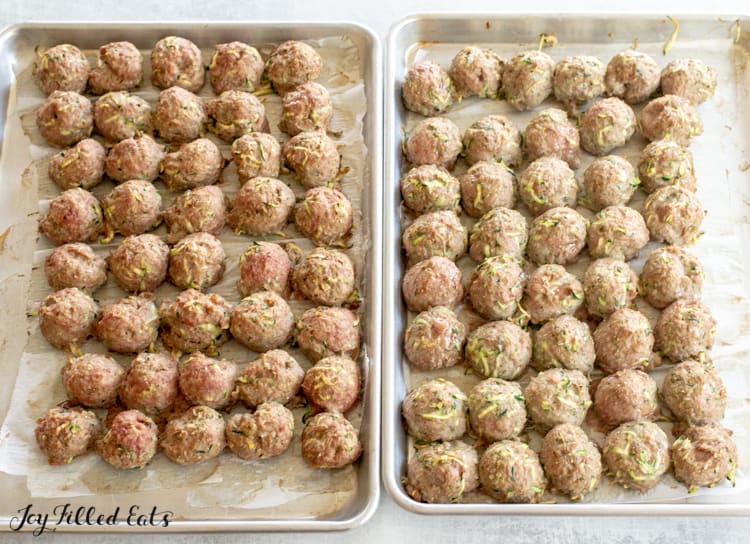 two sheet pans lined with turkey meatballs