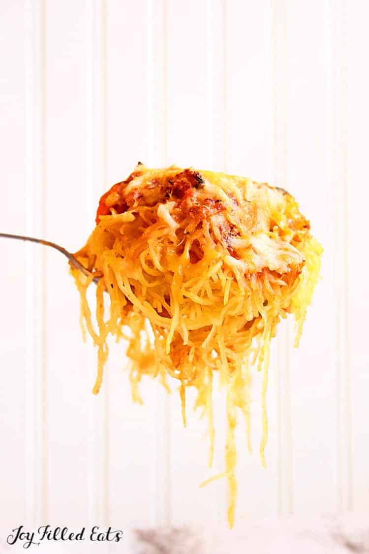 fork lifting a bite of baked spaghetti squash