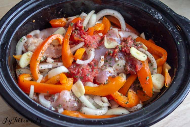 slow cooker filled with ingredients for chicken cacciatore