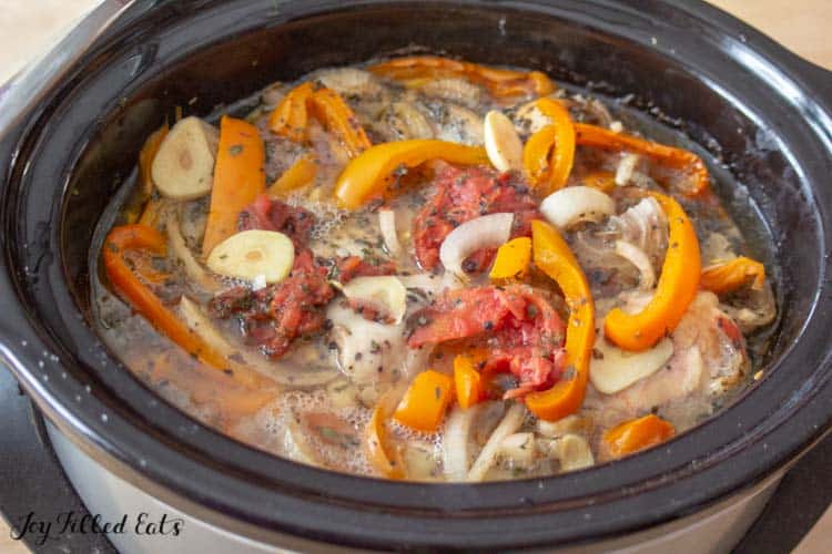 slow cooker filled with cooked ingredients for chicken cacciatore