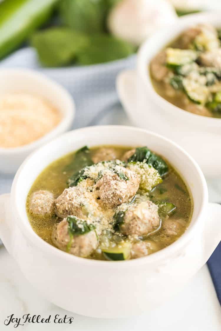 two bowls of keto meatball soup on table setting
