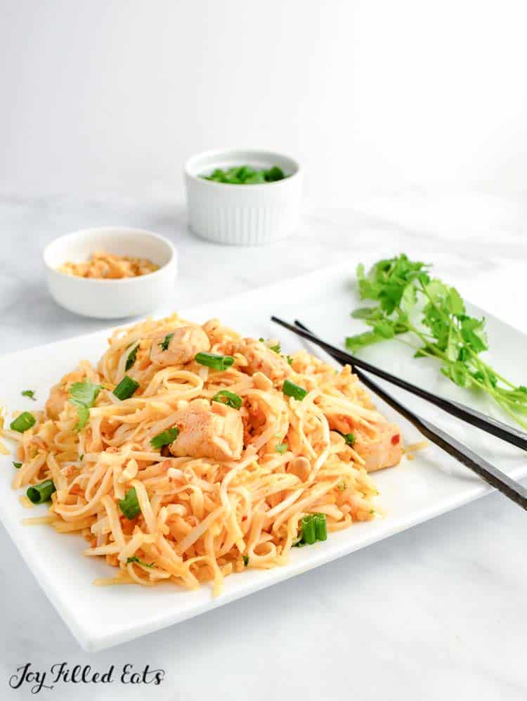 keto chicken pad thai on white plate with chopsticks