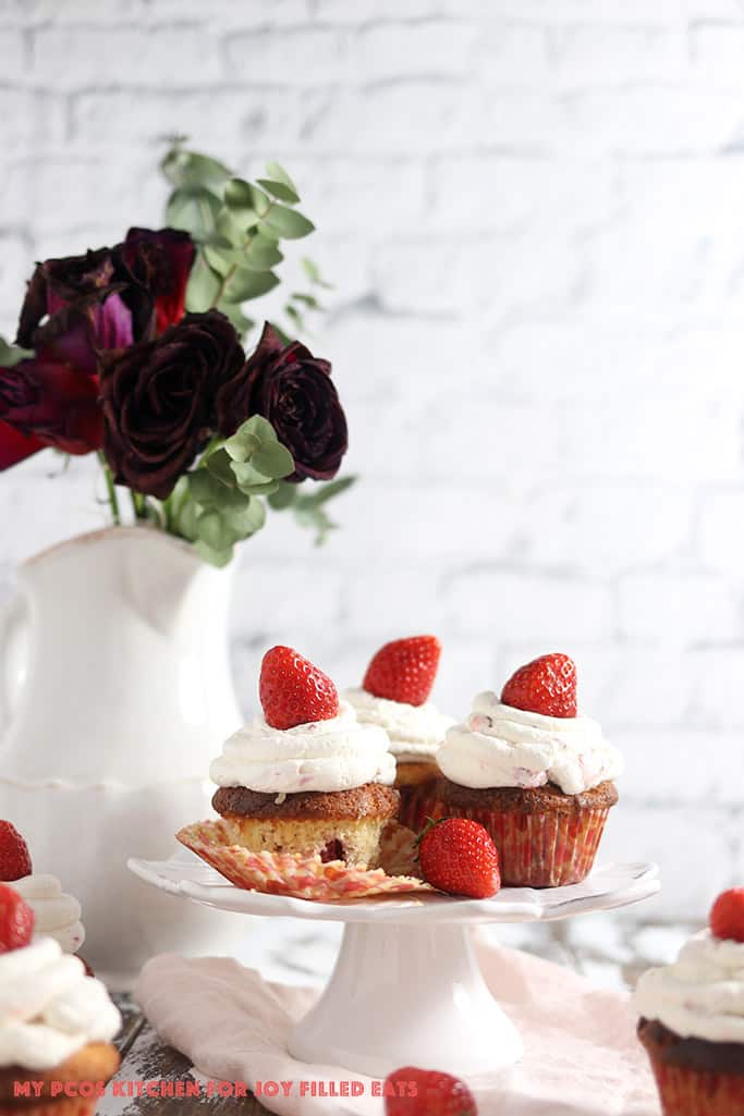 Sour cream vanilla low carb cupcakes made with strawberries on a cake plate