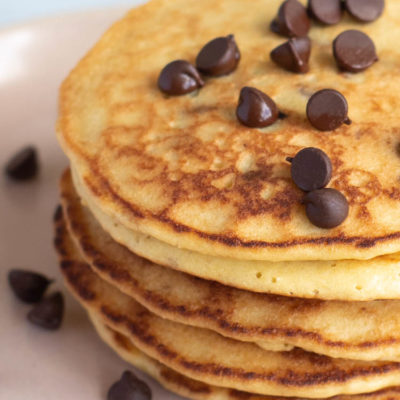 close up on stack of almond flour pancakes topped with chocolate chips