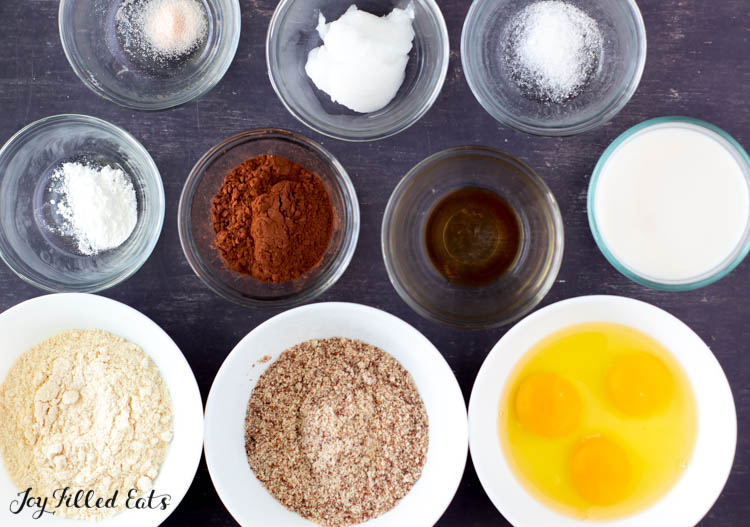 ingredients for keto chocolate cupcakes placed in individual containers from above