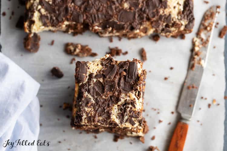 keto choclate cake bar with cheesecake swirl topped with chocolate shavings from above