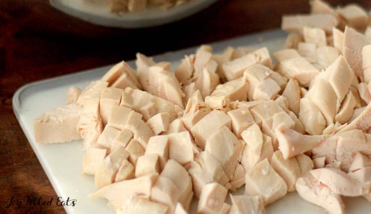 diced cooked chicken on cutting board