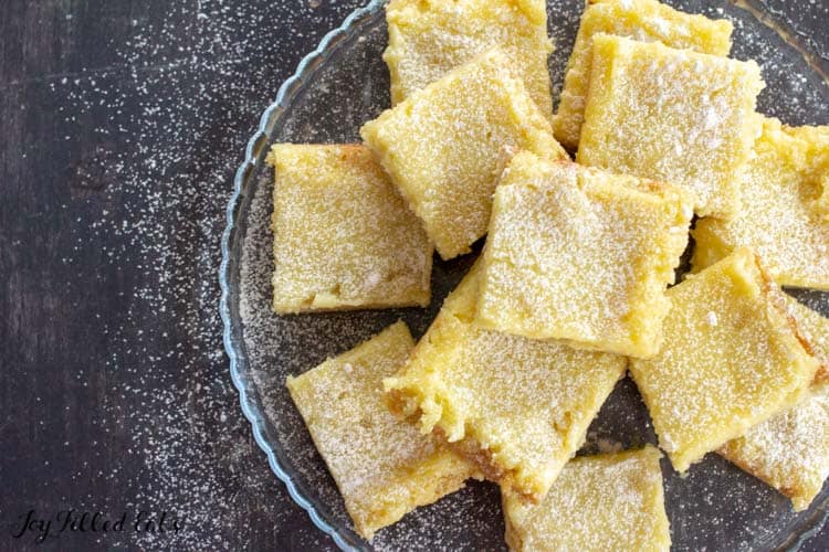 pile of sugar free lemon bars on a glass plate from above