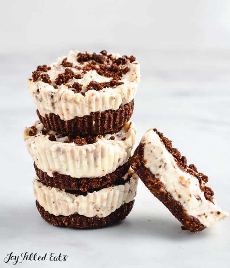 stack of no-bake oreo cheesecake bites with one leaning on stack from ground