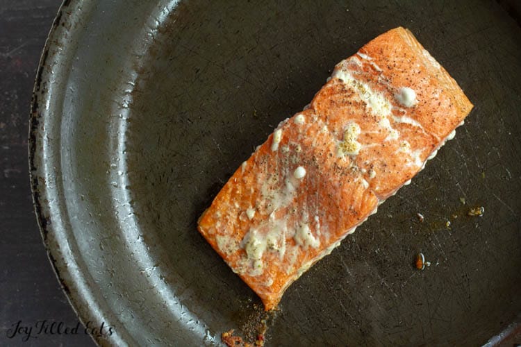 salmon filet cooking in skillet