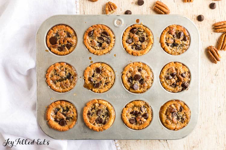 muffin tin filled with chocolate chip topped tassies