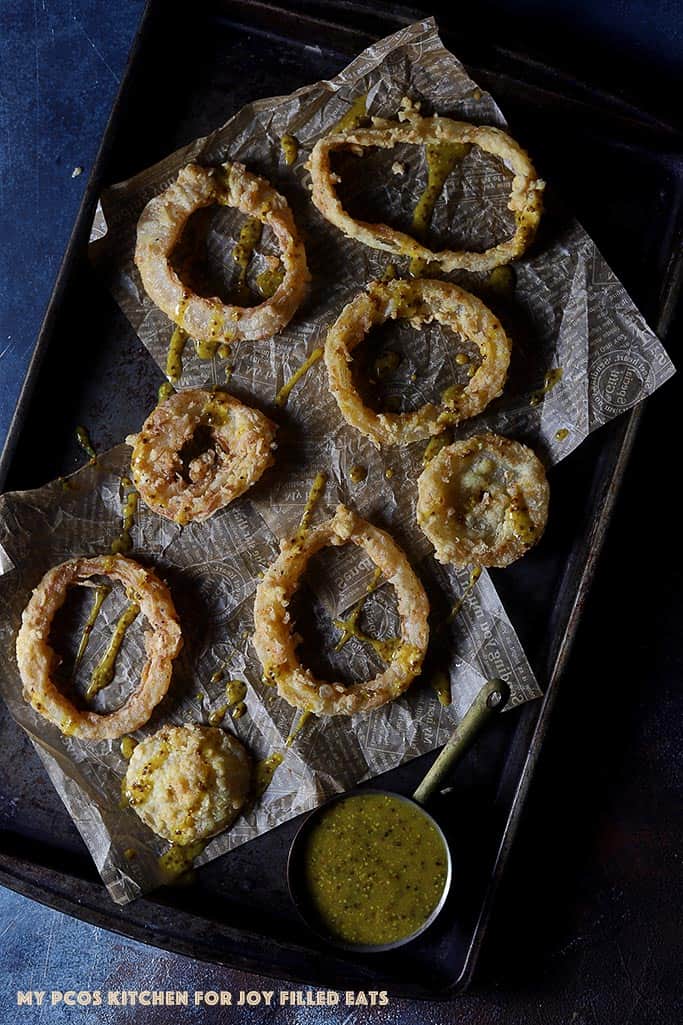 low carb onion rings with honey mustard sauce on a baking tray