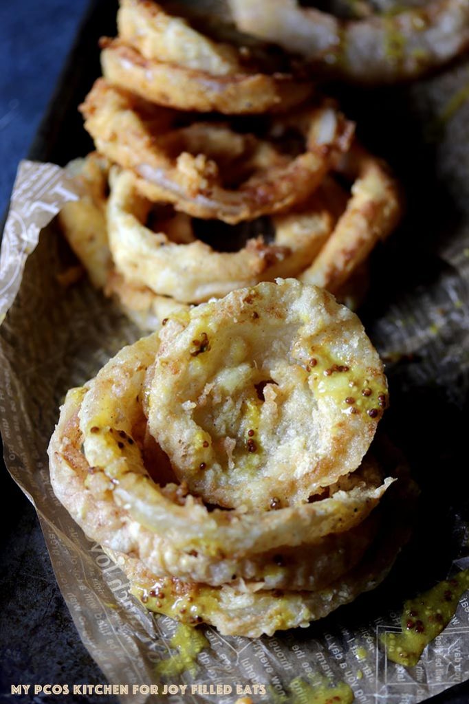 keto onion rings stacked on top of one another.