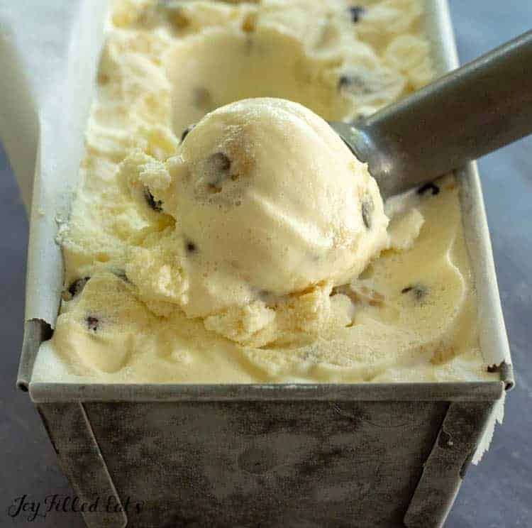 cookie dough ice cream and scoop within metal container close up