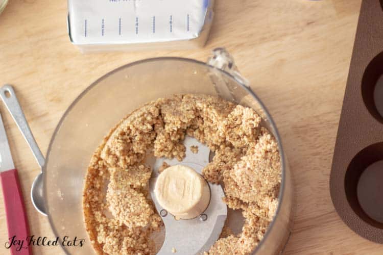 overhead view of food processor with cheesecake crust dough