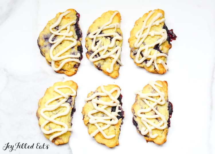 six blueberry turnovers drizzled in icing from above