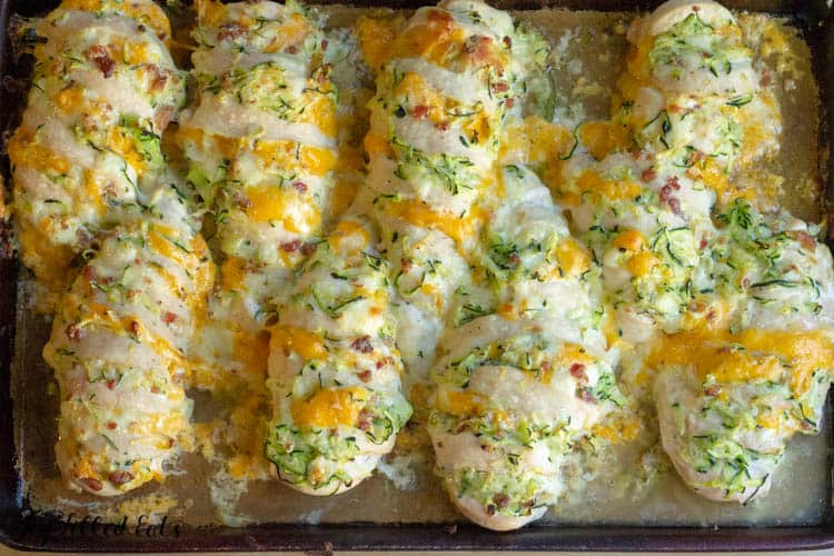 Overhead shot of four cheese bacon hasselback chicken breasts on sheet pan