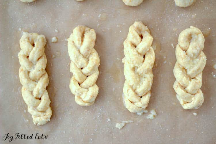 braided breadstick dough on parchment before baking