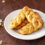 pile of keto braided breadsticks on a white plate
