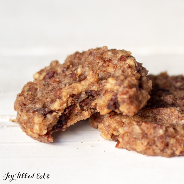 Close up of two Chocolate Chip Pecan Cookies with big bite taken out of one