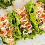 three lettuce wrapped crockpot chicken tacos drizzled in sour cream from above