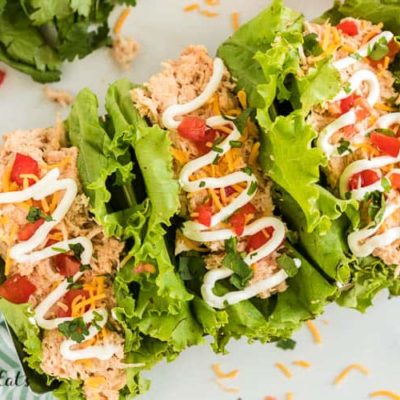three lettuce wrapped crockpot chicken tacos drizzled in sour cream from above