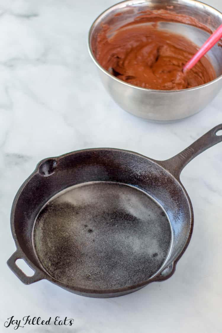 empty skillet next to mixing bowl of brownie batter