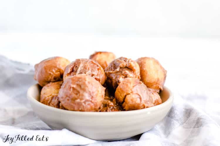 a bowl of keto donut holes on a blue and white table setting