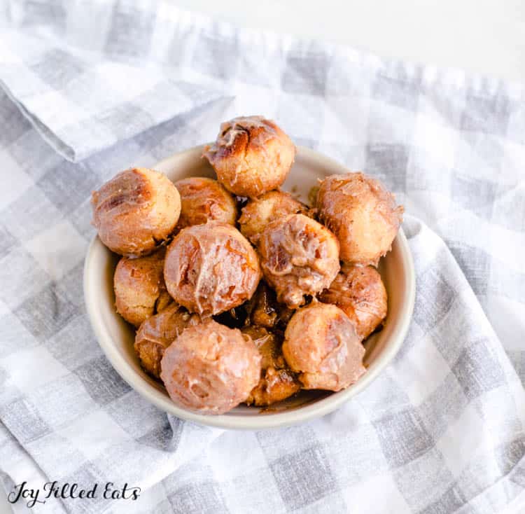 a bowl of keto donut holes shown from above on a blue and white plaid table setting