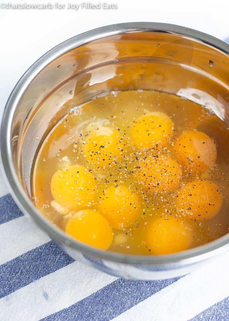 Mixing bowl of seasoned cracked raw eggs