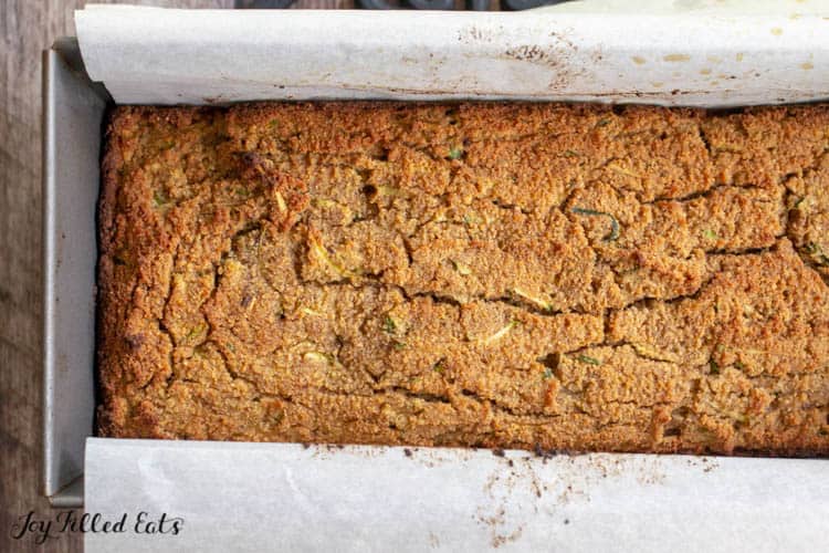 keto zucchini bread loaf in parchment lined bread pan