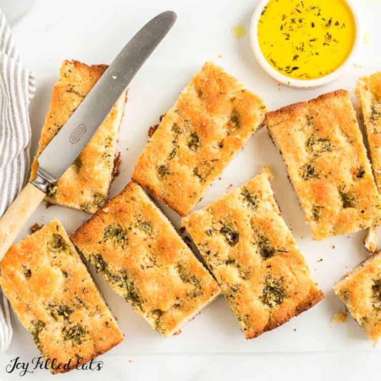 keto garlic bread portions with herb butter and butter knife