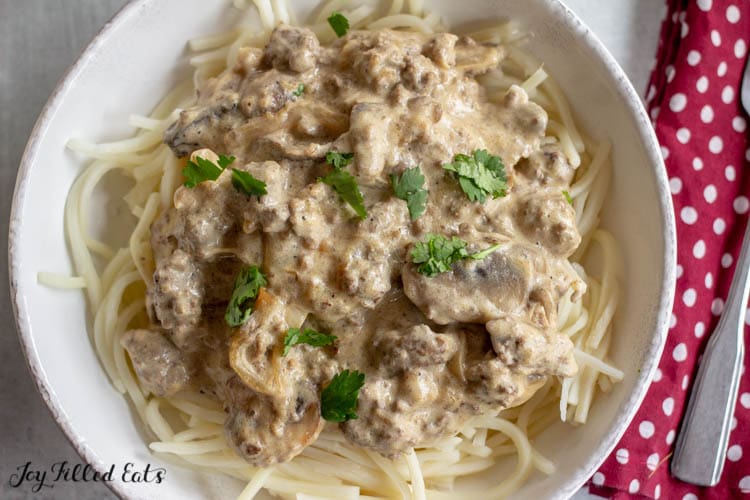 Overhead view of white bowl filled with ground beef stroganoff