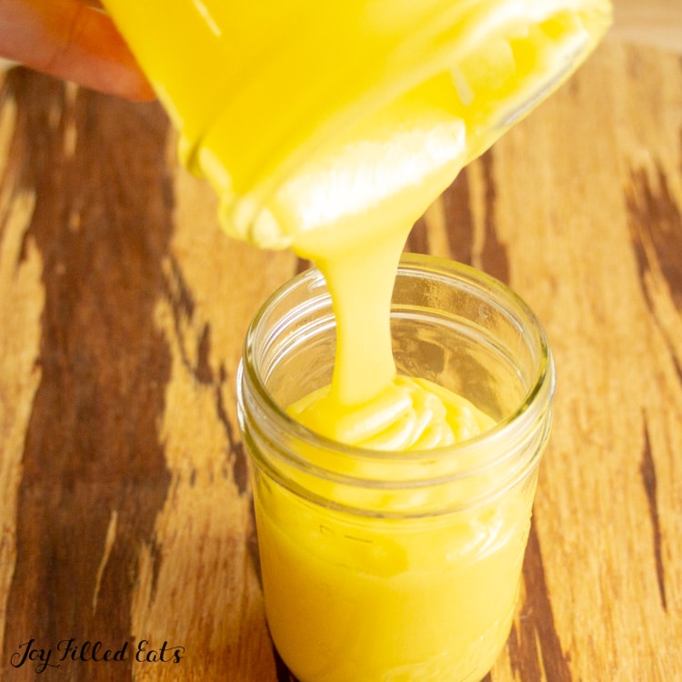 keto lime curd being poured into a mason jar