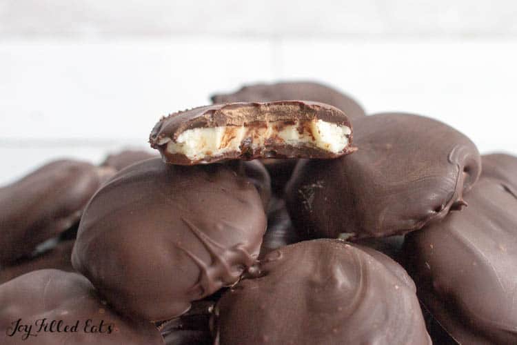 pile of homemade peppermint patties with bite missing from top candy