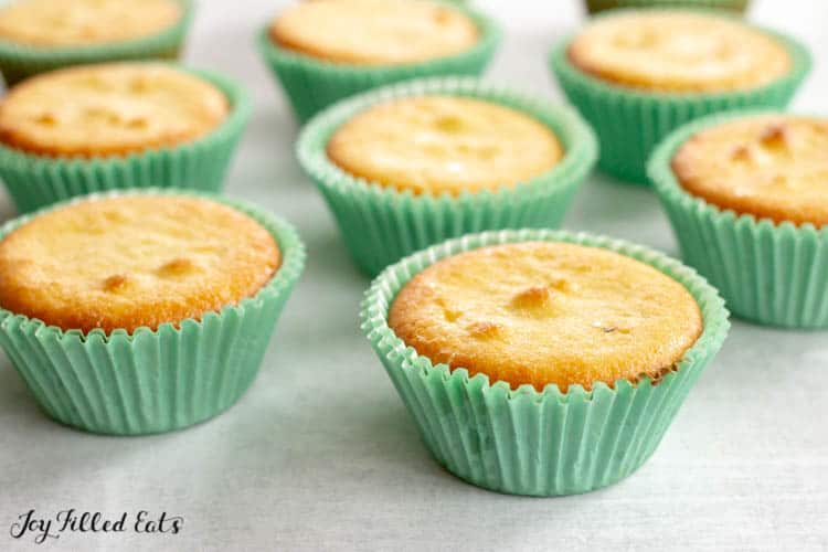 Unfrosted almond flour cupcakes in light blue cupcake wrappers