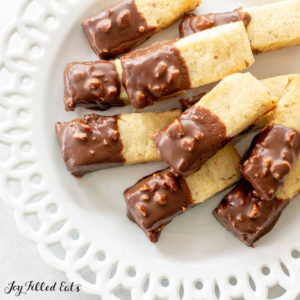 Keto Almond Shortbread Cookies dipped in chocolate on white plate