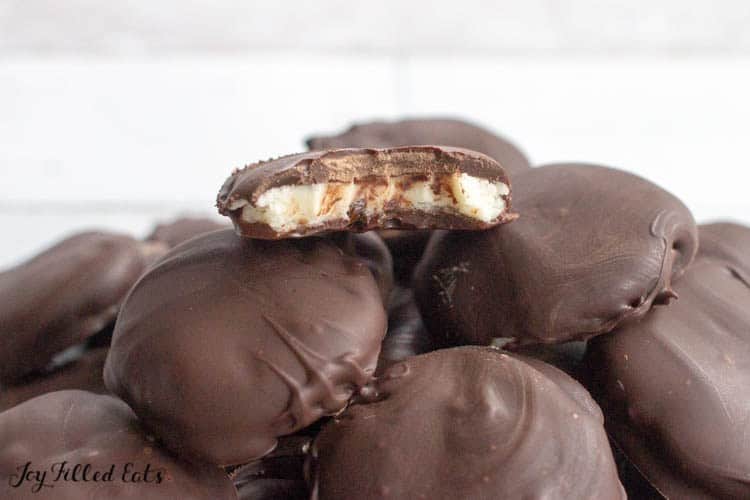 Pile of homemade peppermint patties with top piece missing large bite